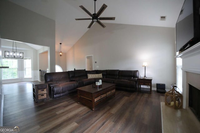 262 Devynwood Ln, Dallas, GA 30157 - living room with wood finished floors, high vaulted ceiling, ceiling fan, a fireplace with raised hearth, and a chandelier