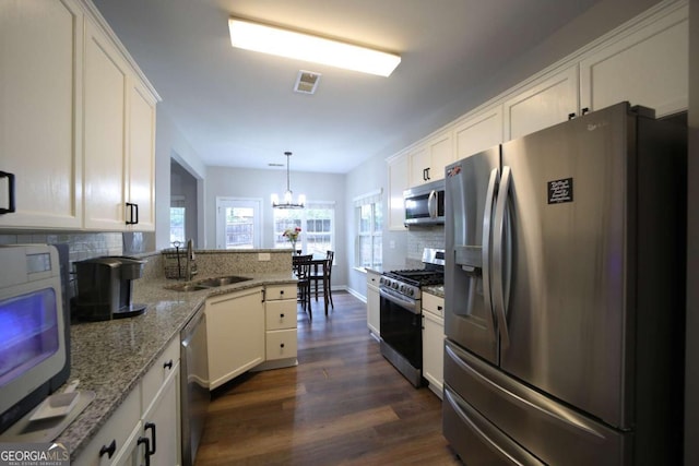 262 Devynwood Ln, Dallas, GA 30157 - kitchen featuring stainless steel appliances, backsplash, white cabinets, a peninsula, and dark wood-type flooring