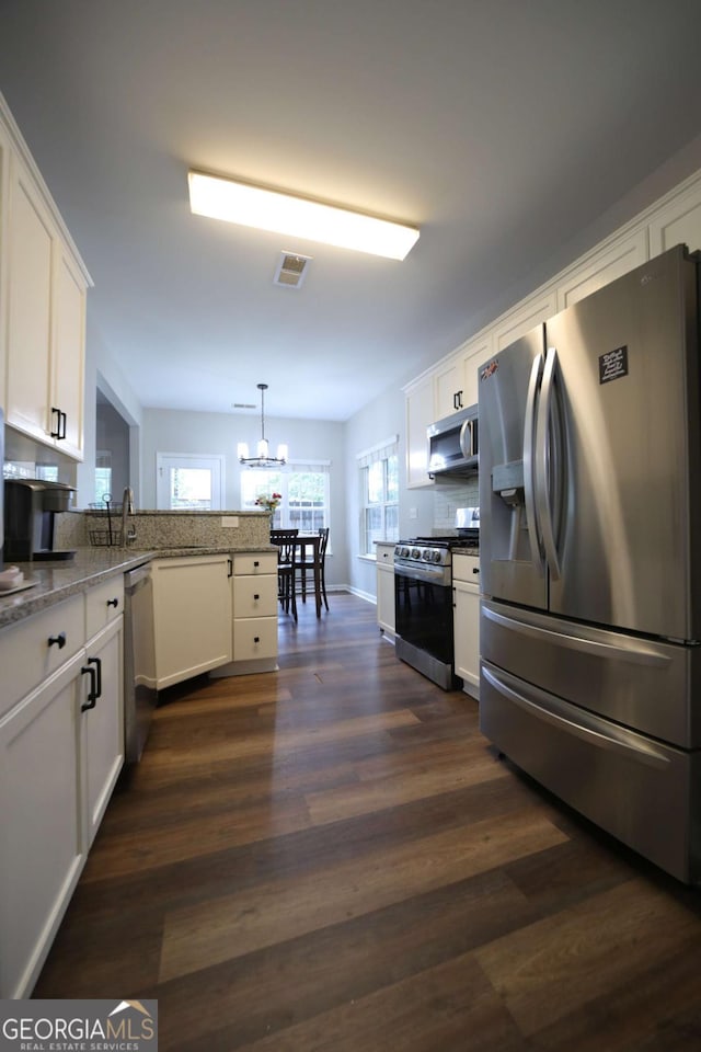 262 Devynwood Ln, Dallas, GA 30157 - kitchen featuring stainless steel appliances, white cabinets, a chandelier, and dark wood finished floors