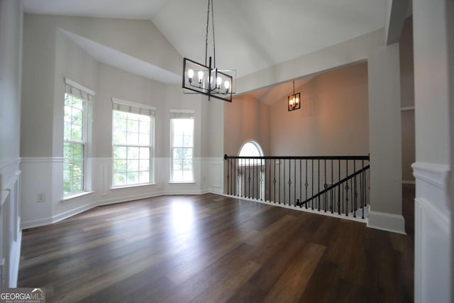 262 Devynwood Ln, Dallas, GA 30157 - spare room with a chandelier, vaulted ceiling, wood finished floors, wainscoting, and a decorative wall