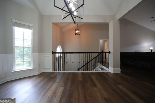 262 Devynwood Ln, Dallas, GA 30157 - empty room featuring a chandelier, lofted ceiling, wood finished floors, healthy amount of natural light, and a wainscoted wall
