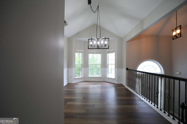 262 Devynwood Ln, Dallas, GA 30157 - unfurnished room featuring a chandelier, a wainscoted wall, wood finished floors, lofted ceiling, and a decorative wall