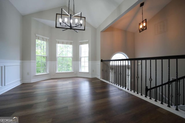 262 Devynwood Ln, Dallas, GA 30157 - hallway with a chandelier, high vaulted ceiling, a wainscoted wall, wood finished floors, and a decorative wall