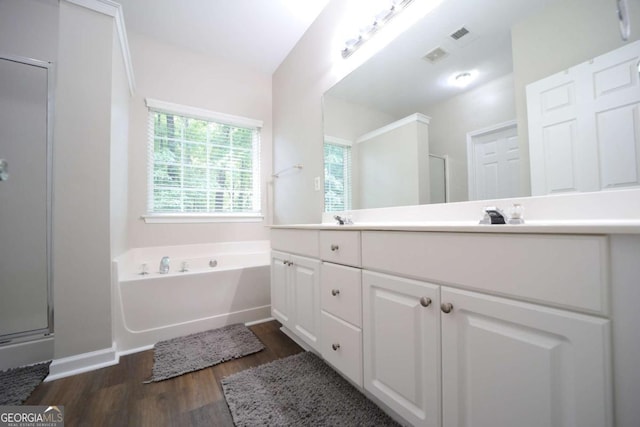 262 Devynwood Ln, Dallas, GA 30157 - bathroom featuring a shower stall, wood finished floors, double vanity, and a garden tub