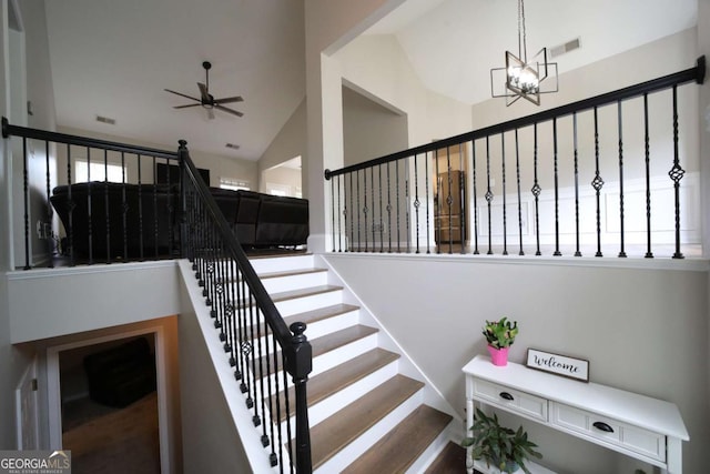 262 Devynwood Ln, Dallas, GA 30157 - stairway featuring high vaulted ceiling, ceiling fan, and a chandelier