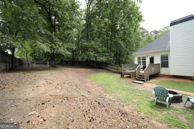 262 Devynwood Ln, Dallas, GA 30157 - fenced backyard with a fire pit and a deck