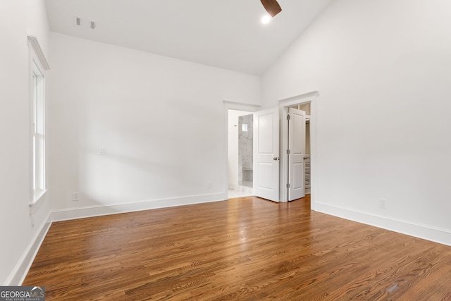 1036 Dell Ave SE, Smyrna, GA 30080 - empty room with wood finished floors, baseboards, a ceiling fan, and high vaulted ceiling