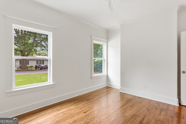1036 Dell Ave SE, Smyrna, GA 30080 - empty room with wood finished floors, crown molding, and baseboards