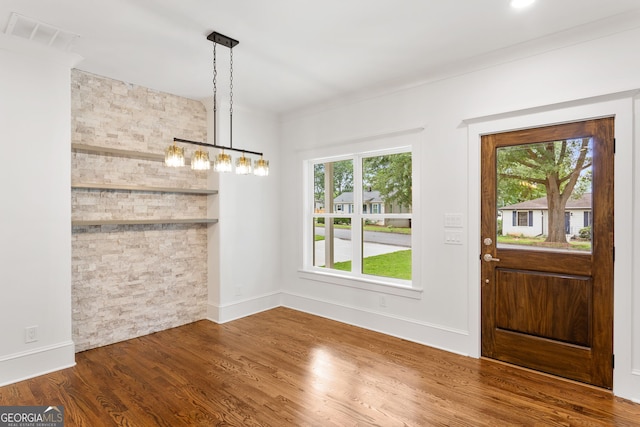 1036 Dell Ave SE, Smyrna, GA 30080 - unfurnished dining area featuring plenty of natural light, wood finished floors, baseboards, and crown molding
