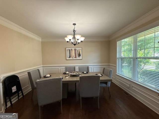 3020 Whitfield Ave, Cumming, GA 30040 - dining space featuring a chandelier, a decorative wall, ornamental molding, dark wood-type flooring, and a wainscoted wall