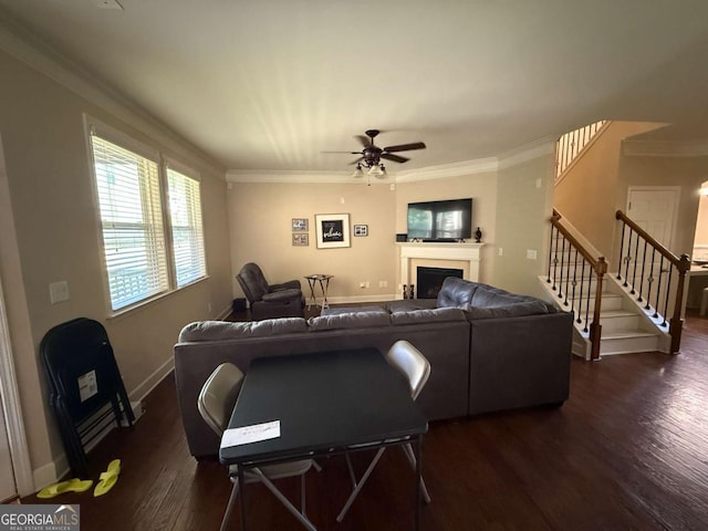 3020 Whitfield Ave, Cumming, GA 30040 - living room with dark wood-type flooring, crown molding, ceiling fan, a fireplace, and stairs