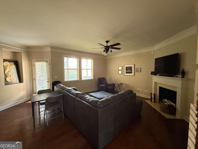3020 Whitfield Ave, Cumming, GA 30040 - living area featuring ornamental molding, a ceiling fan, a fireplace with flush hearth, and dark wood-type flooring