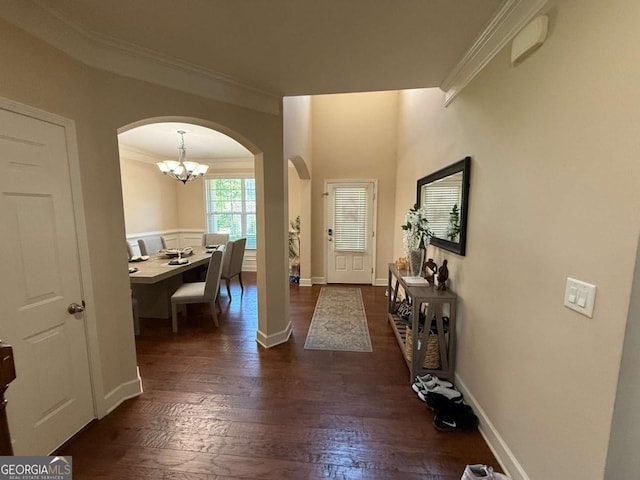 3020 Whitfield Ave, Cumming, GA 30040 - entryway featuring arched walkways, crown molding, wood finished floors, and a chandelier