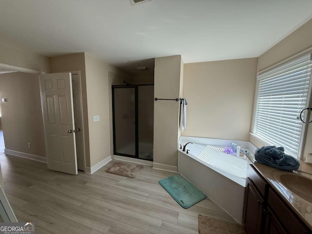 3020 Whitfield Ave, Cumming, GA 30040 - bathroom featuring a stall shower, a bath, wood finished floors, and vanity