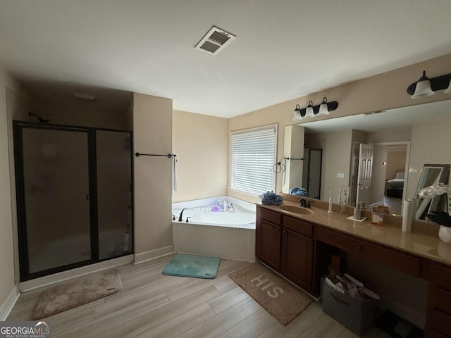 3020 Whitfield Ave, Cumming, GA 30040 - full bathroom featuring a shower stall, a garden tub, vanity, and wood finished floors