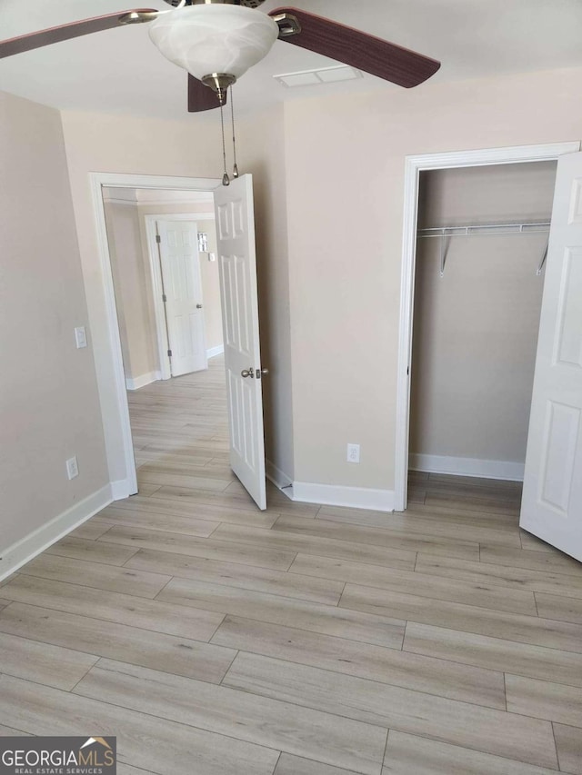 3020 Whitfield Ave, Cumming, GA 30040 - unfurnished bedroom featuring a closet, light wood finished floors, and a ceiling fan