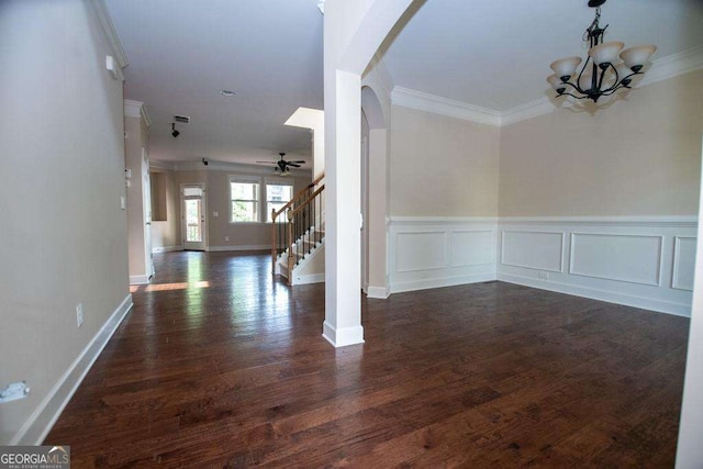 3020 Whitfield Ave, Cumming, GA 30040 - unfurnished dining area with crown molding, arched walkways, stairs, dark wood-style flooring, and ceiling fan
