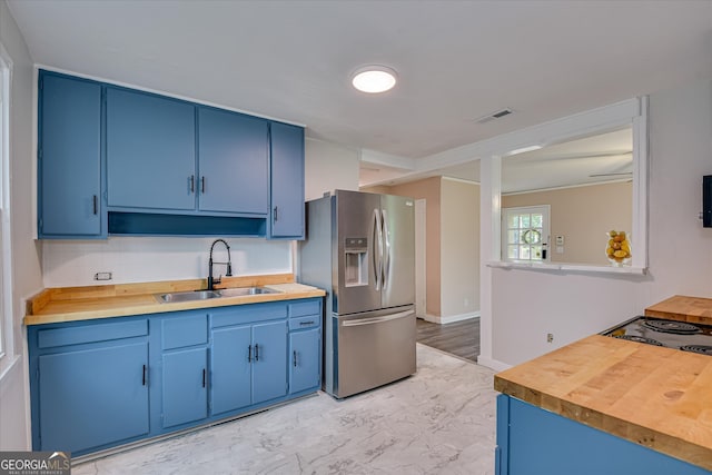 2325 Henry Cir, Augusta, GA 30906 - kitchen featuring stainless steel fridge with ice dispenser, blue cabinets, a sink, and wooden counters