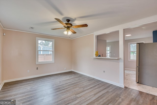 2325 Henry Cir, Augusta, GA 30906 - spare room featuring wood finished floors, ceiling fan, baseboards, and crown molding