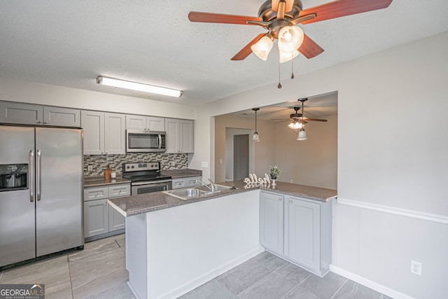 755 Madison Dr, Hinesville, GA 31313 - kitchen with appliances with stainless steel finishes, gray cabinets, ceiling fan, a sink, and a textured ceiling
