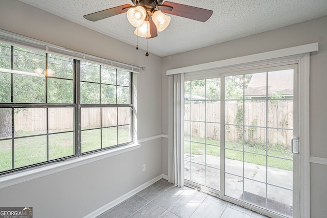 755 Madison Dr, Hinesville, GA 31313 - doorway to outside featuring plenty of natural light, light tile patterned floors, a textured ceiling, a ceiling fan, and baseboards