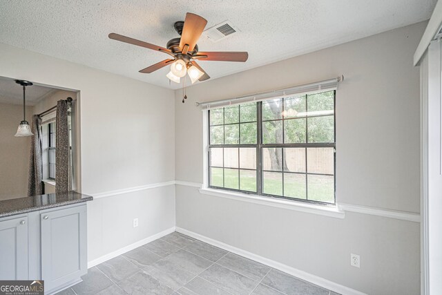 755 Madison Dr, Hinesville, GA 31313 - unfurnished room with ceiling fan, baseboards, a textured ceiling, and light tile patterned floors