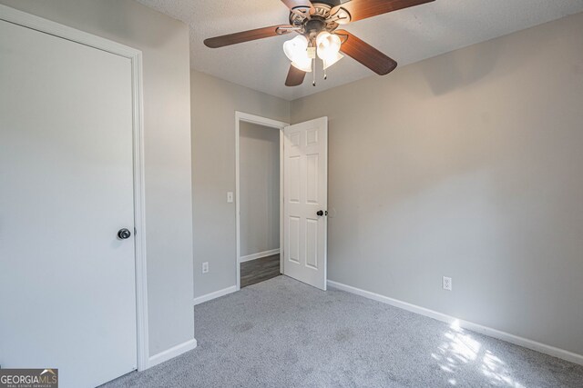 755 Madison Dr, Hinesville, GA 31313 - unfurnished bedroom with carpet floors, baseboards, and a ceiling fan