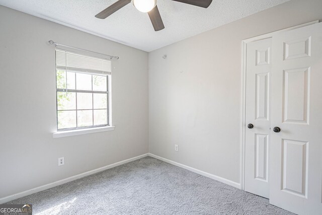 755 Madison Dr, Hinesville, GA 31313 - empty room featuring a ceiling fan, carpet floors, baseboards, and a textured ceiling