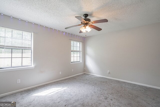 755 Madison Dr, Hinesville, GA 31313 - empty room with carpet, a ceiling fan, a textured ceiling, and baseboards