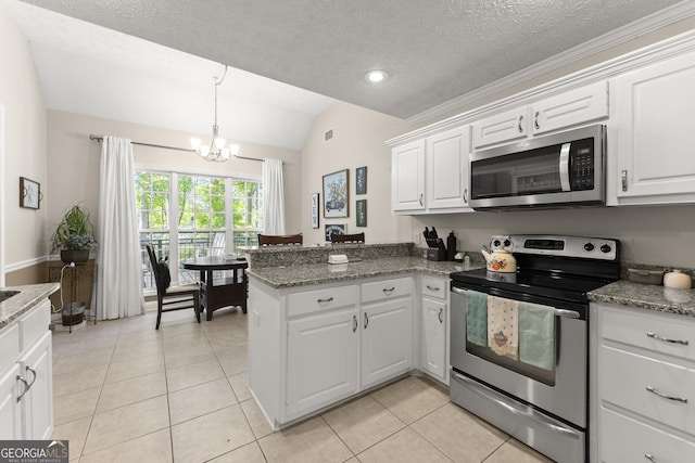 92 Isaiah Dr, Jefferson, GA 30549 - kitchen with stainless steel appliances, vaulted ceiling, a chandelier, light tile patterned flooring, and a peninsula