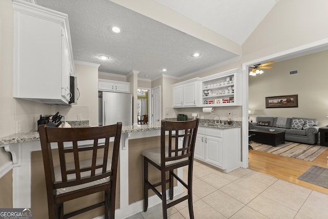 92 Isaiah Dr, Jefferson, GA 30549 - kitchen with appliances with stainless steel finishes, a peninsula, open shelves, light stone countertops, and crown molding