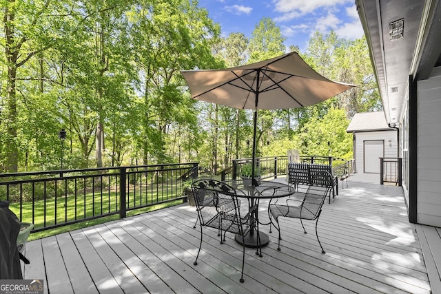 92 Isaiah Dr, Jefferson, GA 30549 - deck featuring outdoor dining area and view of wooded area
