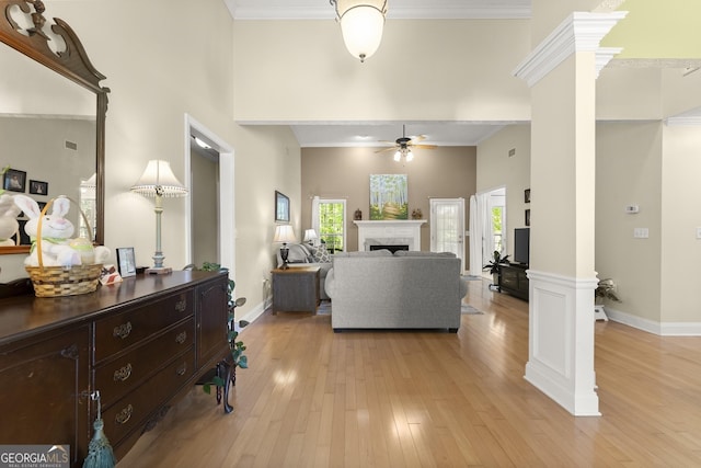 92 Isaiah Dr, Jefferson, GA 30549 - living area with ornate columns, ceiling fan, light wood-style floors, baseboards, and crown molding