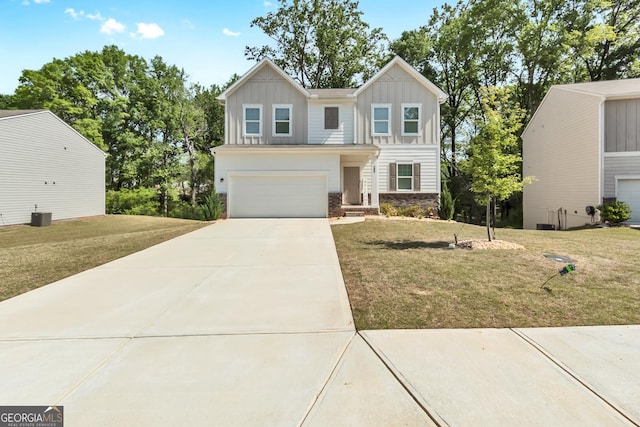 289 Pond Ct, Hoschton, GA 30548 - view of front of property with board and batten siding, concrete driveway, stone siding, and a front yard