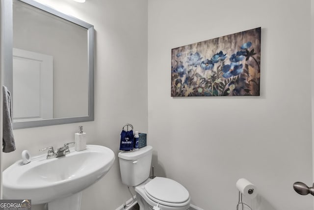 289 Pond Ct, Hoschton, GA 30548 - bathroom featuring a sink, toilet, and baseboards