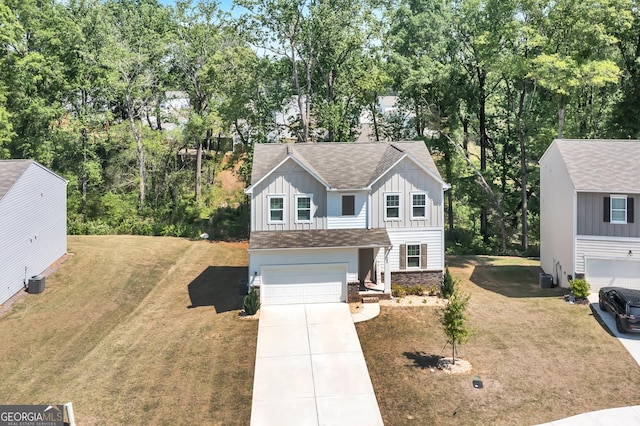 289 Pond Ct, Hoschton, GA 30548 - traditional home featuring board and batten siding, concrete driveway, a garage, a front yard, and roof with shingles