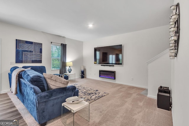 289 Pond Ct, Hoschton, GA 30548 - carpeted living area with baseboards and a glass covered fireplace