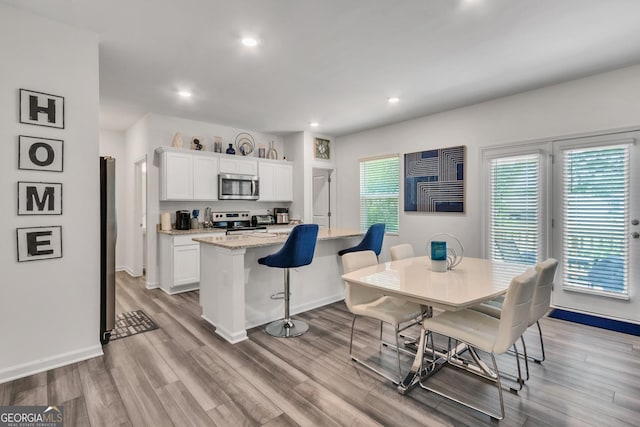 289 Pond Ct, Hoschton, GA 30548 - dining area with baseboards, wood finished floors, and recessed lighting