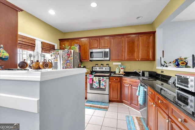 2205 Hoskin Ct NW Unit 9, Kennesaw, GA 30144 - kitchen featuring appliances with stainless steel finishes, a sink, light tile patterned flooring, brown cabinets, and recessed lighting