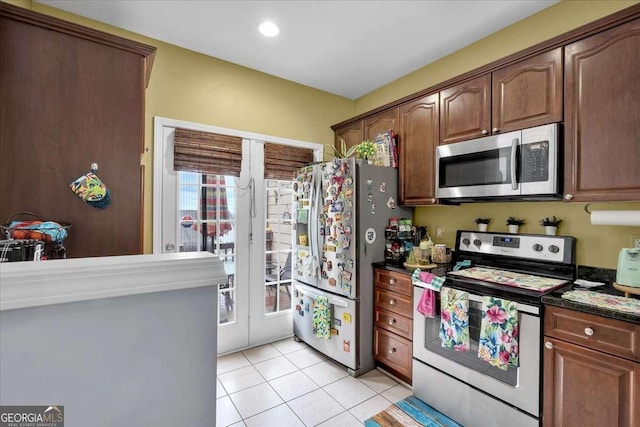 2205 Hoskin Ct NW Unit 9, Kennesaw, GA 30144 - kitchen with appliances with stainless steel finishes, dark countertops, light tile patterned floors, french doors, and recessed lighting