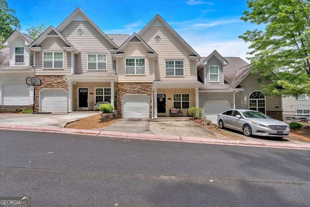 2205 Hoskin Ct NW Unit 9, Kennesaw, GA 30144 - multi unit property featuring stone siding, an attached garage, and driveway