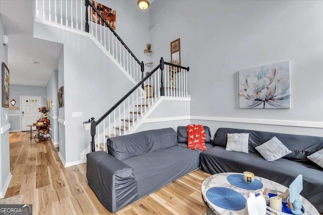 2205 Hoskin Ct NW Unit 9, Kennesaw, GA 30144 - living area with stairs, wood finished floors, a high ceiling, and baseboards