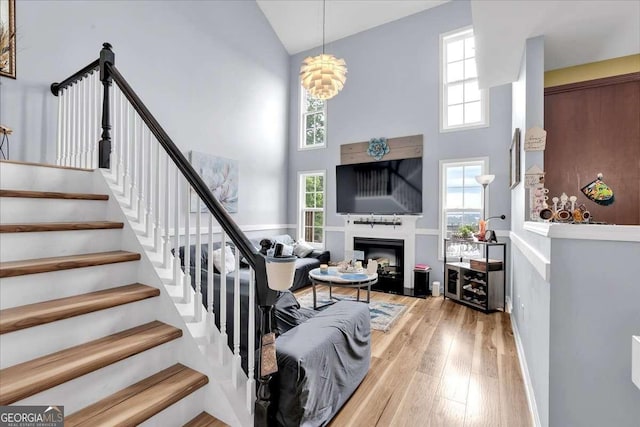 2205 Hoskin Ct NW Unit 9, Kennesaw, GA 30144 - stairs with high vaulted ceiling, wood finished floors, a glass covered fireplace, and baseboards