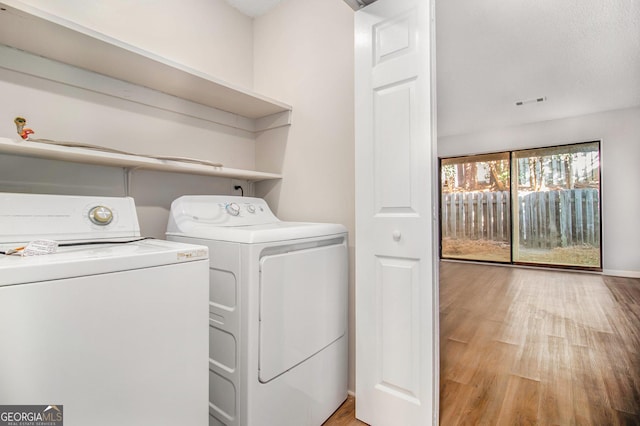 2220 Runnymead Rdg SE, Marietta, GA 30067 - laundry area with independent washer and dryer and light wood finished floors