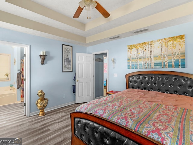 2040 Elm Grove Ln, Hampton, GA 30228 - bedroom with wood finished floors, baseboards, connected bathroom, and ceiling fan