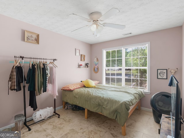 2040 Elm Grove Ln, Hampton, GA 30228 - bedroom featuring baseboards, a textured ceiling, and ceiling fan
