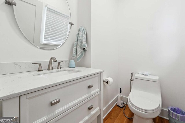 5535 Buck Hollow Dr, Alpharetta, GA 30005 - half bathroom with vanity and wood finished floors
