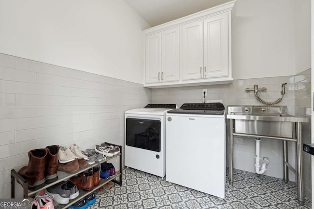 5535 Buck Hollow Dr, Alpharetta, GA 30005 - washroom featuring cabinet space, tile walls, and washer and clothes dryer