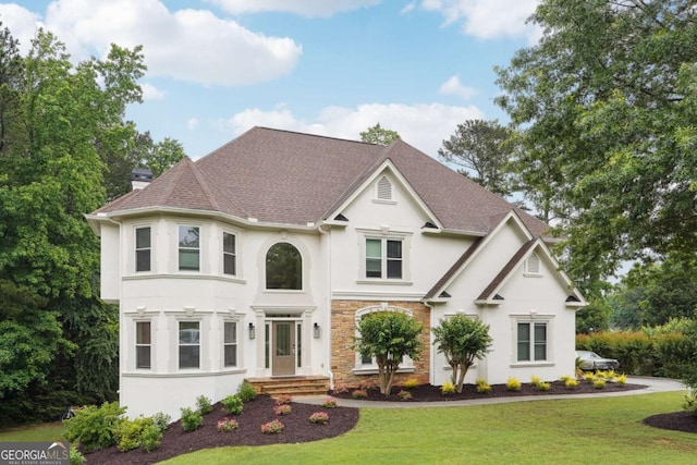 5535 Buck Hollow Dr, Alpharetta, GA 30005 - view of front of house featuring stucco siding, a front yard, a chimney, and stone siding