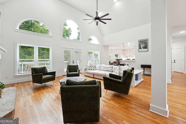 5535 Buck Hollow Dr, Alpharetta, GA 30005 - living room with high vaulted ceiling, a ceiling fan, and light wood-style floors